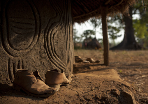 Old Shoes In Front Of An Anuak Traditional Hut In Abobo, The Former Anuak King Village, Gambela Region, Ethiopia