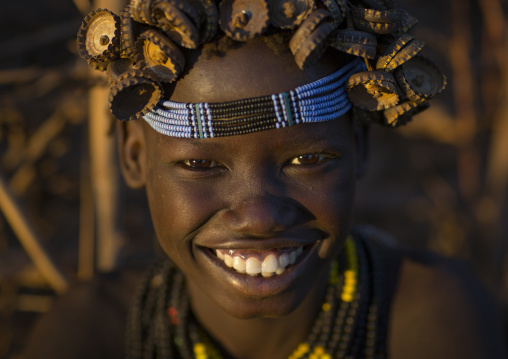 Portrait Of A Young Dassanech Girl Wearing Bottle Caps Headgear And Beaded Necklaces, Omorate, Omo Valley, Ethiopia