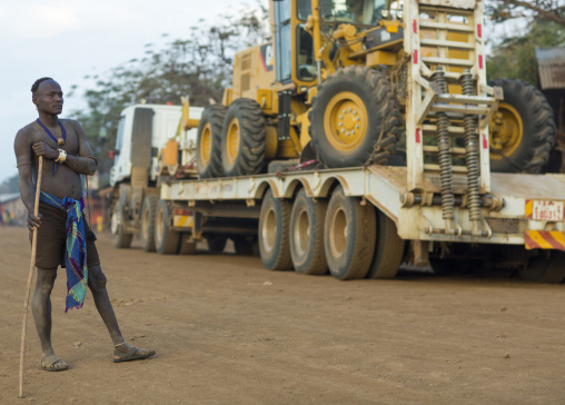 Bodi Tribe Warrior Posing Proudly On A Bulldozer In Hana Mursi, Omo Valley, Ethiopia