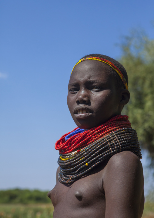 Portrait Of A Nyangatom Tribe Girl With Huge And Colourful Necklaces, Omo Valley, Kangate, Ethiopia