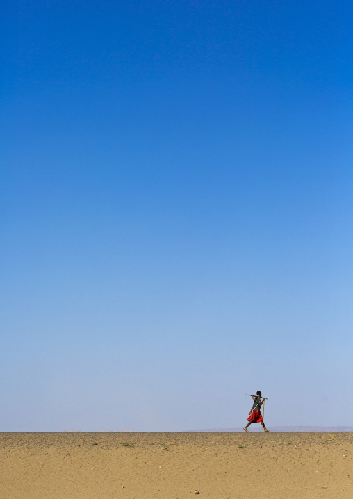 Afar Tribe Man Walking Alone In The Desert, Assayta, Ethiopia