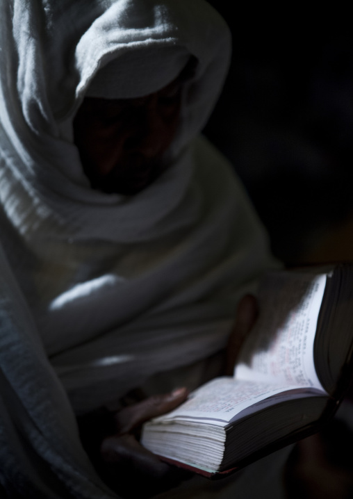 Orthodox Pilgrim Reading The Bible At Timkat Festival, Lalibela, Ethiopia