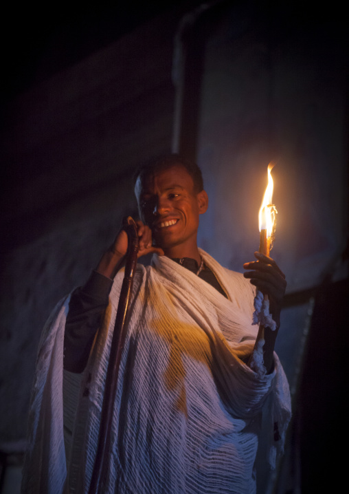 Priest Holding A Candle Inside A Rock Church, Lalibela, Ethiopia