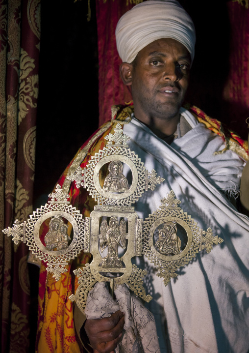 Priest Holding A Cross Inside Yemrehana Krestos Rock Church, Lalibela, Ethiopia