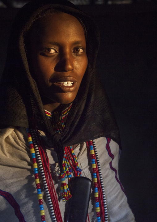 Karrayyu Tribe Woman Inside Her House Lighten By A Ray Of Light, Metahara, Ethiopia