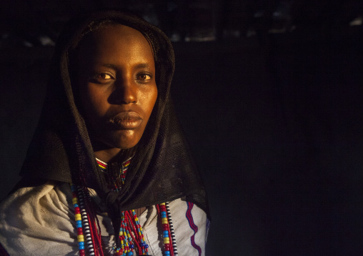 Karrayyu Tribe Woman Inside Her House Lighten By A Ray Of Light, Metahara, Ethiopia