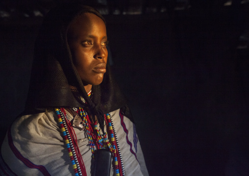 Karrayyu Tribe Woman Inside Her House Lighten By A Ray Of Light, Metahara, Ethiopia