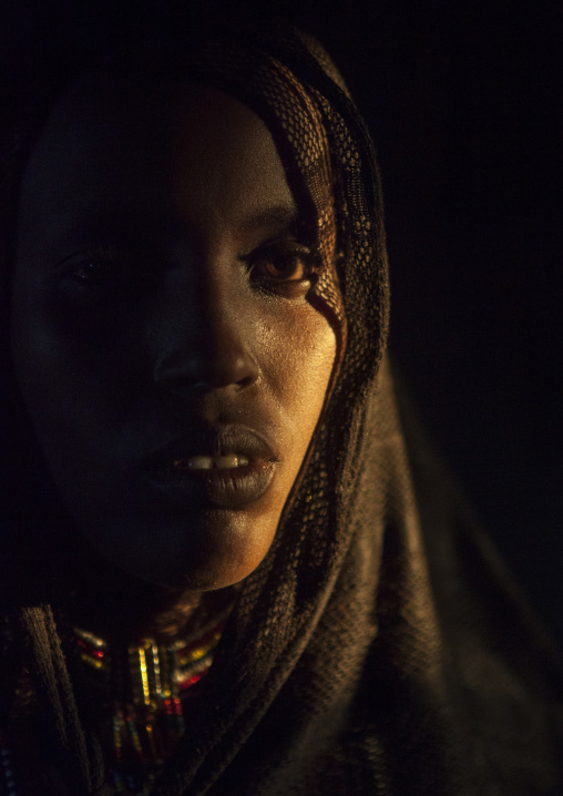 Karrayyu Tribe Woman Inside Her House Lighten By A Ray Of Light, Metahara, Ethiopia