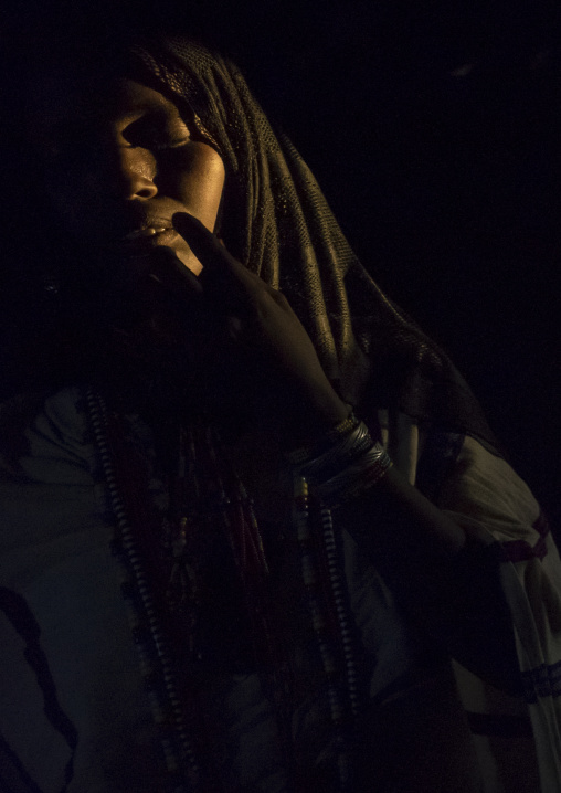 Karrayyu Tribe Woman Inside Her House Lighten By A Ray Of Light, Metahara, Ethiopia