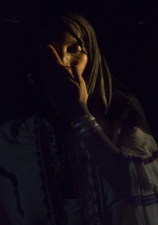 Karrayyu Tribe Woman Inside Her House Lighten By A Ray Of Light, Metahara, Ethiopia