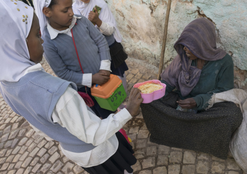 Children Giving Food To A Poor Beggar In The Street, Harar, Ethiopia