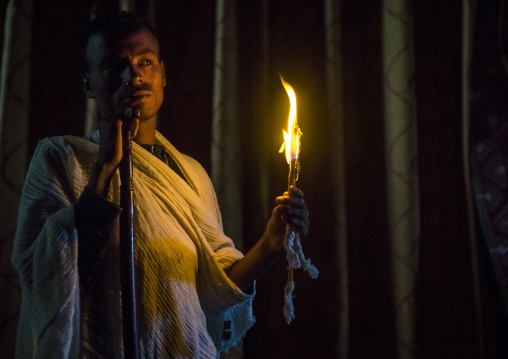 Priest Holding A Candle Inside A Rock Church, Lalibela, Ethiopia