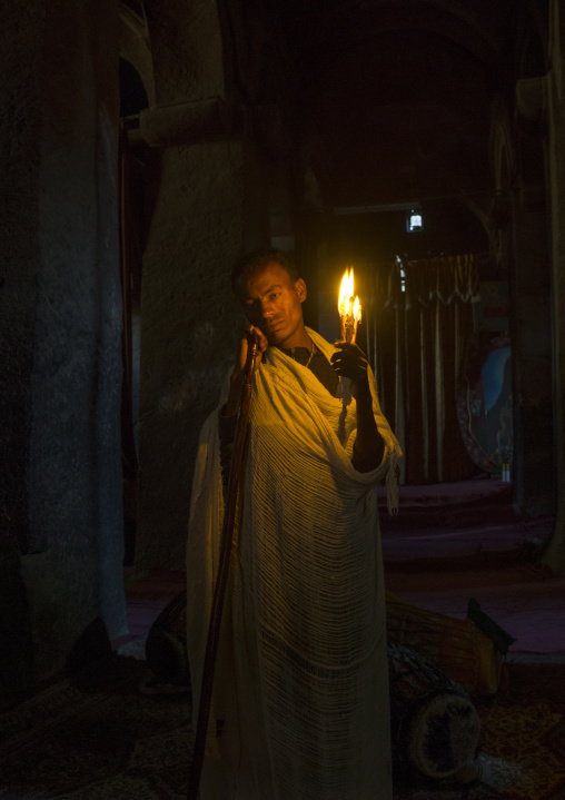 Priest Holding A Candle Inside A Rock Church, Lalibela, Ethiopia