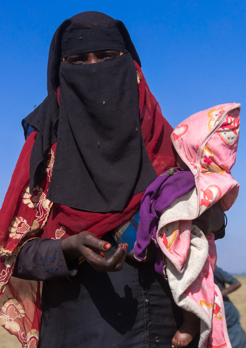 Ethiopian oromo mother with her baby dressed in burqa, Amhara region, Artuma, Ethiopia