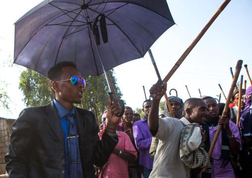 Oromo groom with an umbrella during his wedding celebration, Oromo, Sambate, Ethiopia