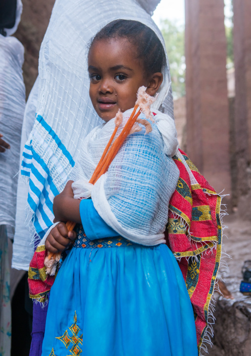 Pilgrim girl with candles during kidane mehret orthodox celebration, Amhara region, Lalibela, Ethiopia