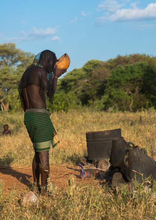 Hamer tribe whipper drinking during a bull jumping ceremony, Omo valley, Turmi, Ethiopia