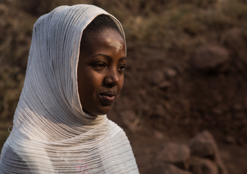 Ethiopian pilgrim woman with a cross sign on the forehead during kidane mehret celebration, Amhara region, Lalibela, Ethiopia