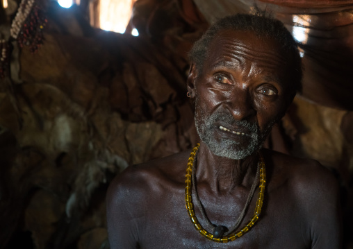 Old hamer tribe man in his hut, Omo valley, Turmi, Ethiopia