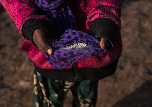 Ethiopian pilgrim woman carrying holy soil during kidane mehret orthodox celebration, Amhara region, Lalibela, Ethiopia