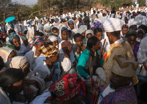 Priest blessing pilgrims during kidane mehret orthodox celebration, Amhara region, Lalibela, Ethiopia