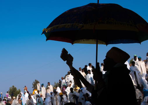 Silhouette of an ethiopian priest blessing the crowd during kidane mehret celebration, Amhara region, Lalibela, Ethiopia