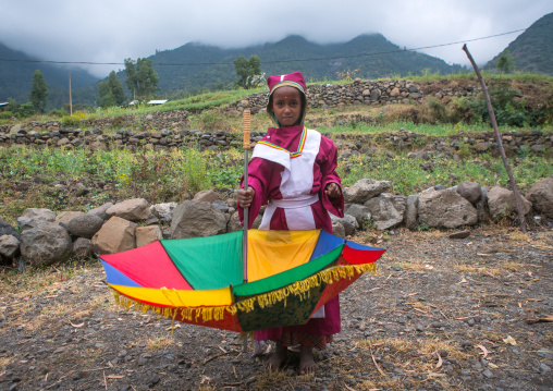 Boy collecting money in an umbrella to build a new church, Semien wollo zone, Woldia, Ethiopia