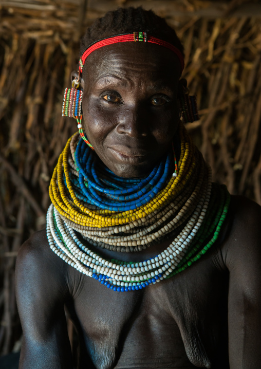 Nyangatom tribe woman with piles of beads, Omo valley, Kangate, Ethiopia