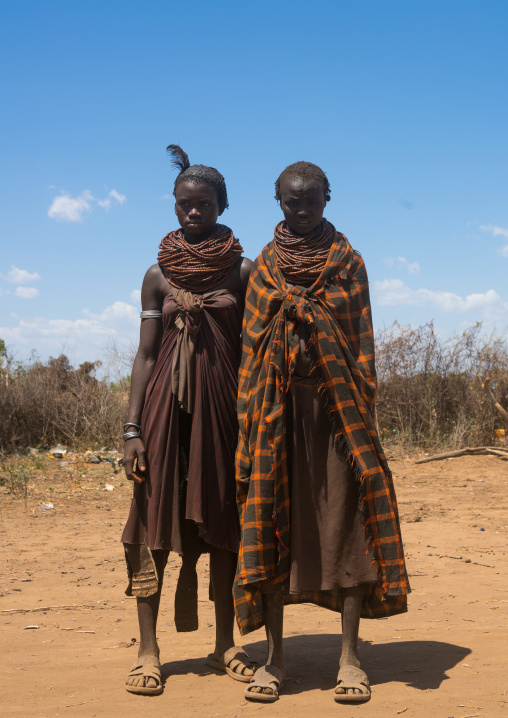 Nyangatom tribe girls with piles of beads, Omo valley, Kangate, Ethiopia