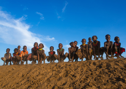 Dassanech tribe children dancing and jumping, Omo valley, Omorate, Ethiopia