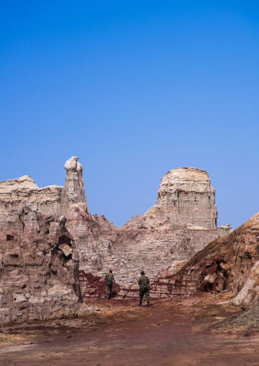 Ethiopian soldiers in the salt canyons made of layers of halite and gypsum in the danakil depression, Afar region, Dallol, Ethiopia