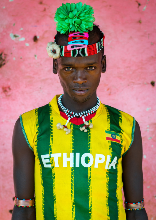 Portrait of a bana tribe man with green plastic flower in the hair, Omo valley, Key afer, Ethiopia