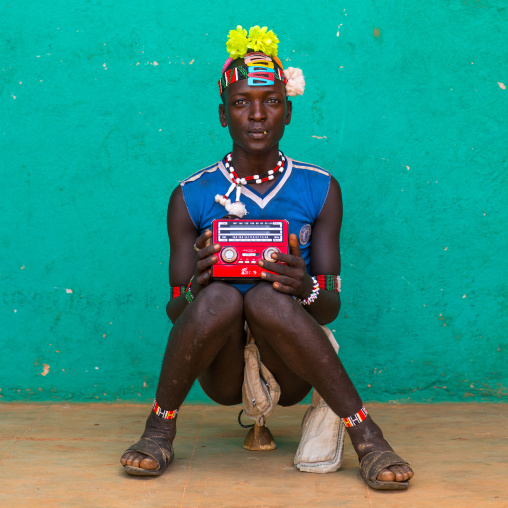 Portrait of a bana tribe man with yellow plastic flower in the hair, Omo valley, Key afer, Ethiopia