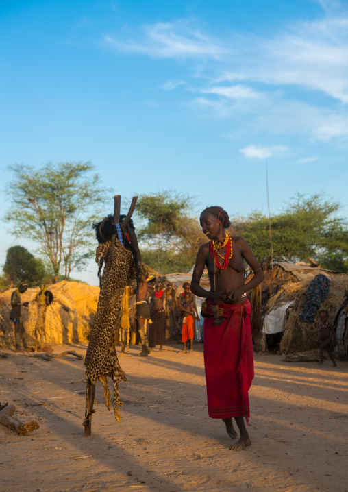 Dassanech tribe woman dressing for the dimi ceremony to celebrate the circumcision of the teenagers, Omo valley, Omorate, Ethiopia