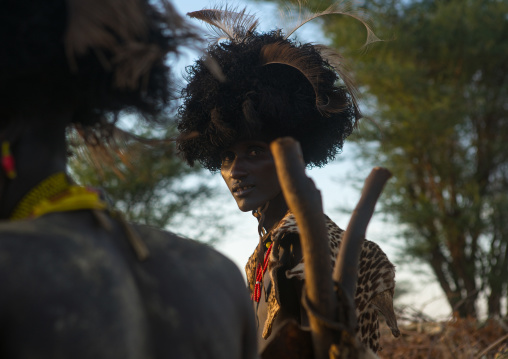 Dassanech men with leopard skins and ostrich feathers headwears during dimi ceremony to celebrate circumcision of teenagers, Omo valley, Omorate, Ethiopia