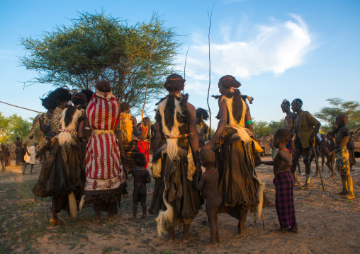 Dassanech men and women during dimi ceremony to celebrate circumcision of teenagers, Omo valley, Omorate, Ethiopia