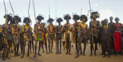 Dassanech men with leopard skins and ostrich feathers headwears during dimi ceremony to celebrate circumcision of teenagers, Omo valley, Omorate, Ethiopia