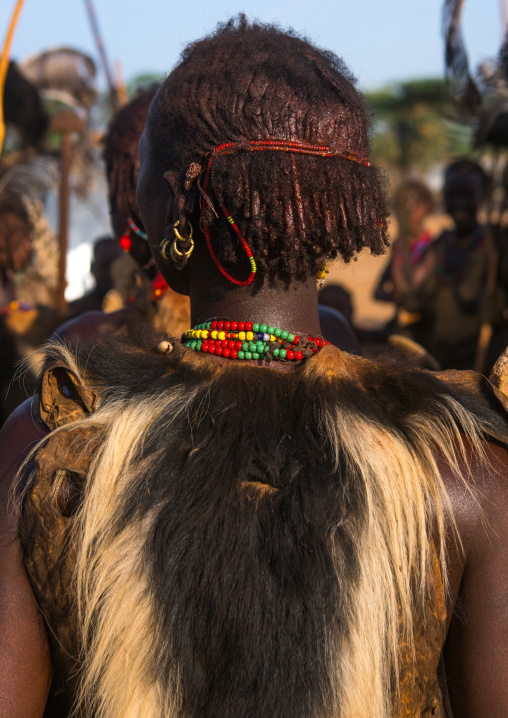 Dassanech tribe woman with colobus monkey skin during dimi ceremony to celebrate circumcision of teenagers, Omo valley, Omorate, Ethiopia