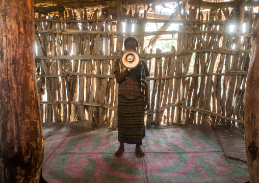 Afat tribe imam inside a wooden mosque calling will a megaphone, Afar region, Afambo, Ethiopia