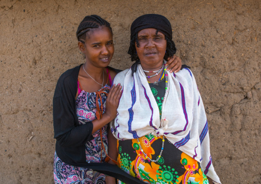 A karrayyu tribe girl called aliya who was the first girl educated in her tribe pausing with her mother, Oromia, Metehara, Ethiopia