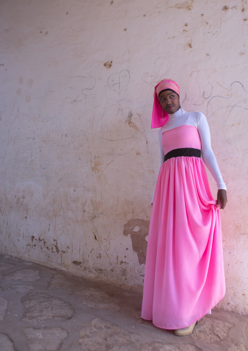 Beautiful teenage girl in pink in the street of the old town, Harari region, Harar, Ethiopia