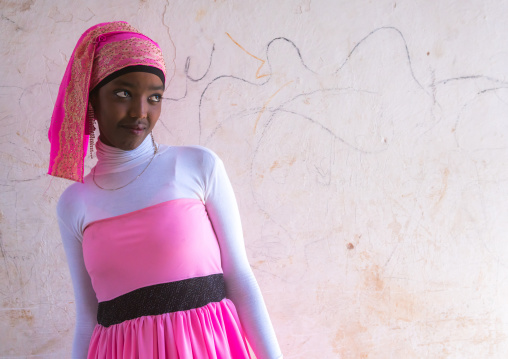 Beautiful teenage girl in pink in the street of the old town, Harari region, Harar, Ethiopia