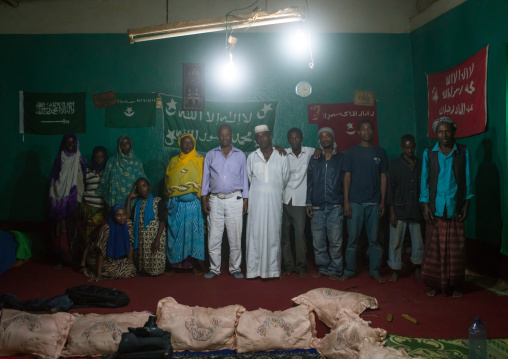 Sufi worshippers in front of islamic flags, Harari region, Harar, Ethiopia