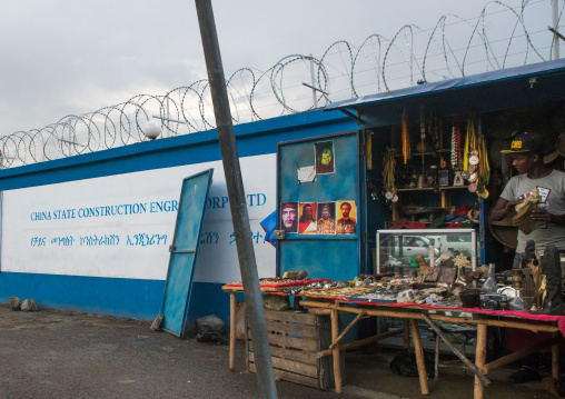 Souvenir seller near a construction site for new building with chinese cooperation, Addis abeba region, Addis ababa, Ethiopia