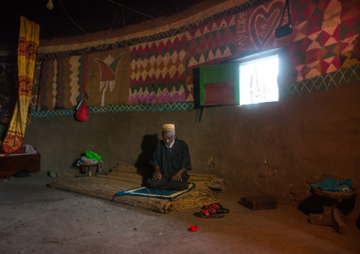 Ethiopia, Kembata, Alaba Kuito, ethiopian muslim man praying inside his traditional painted and decorated house