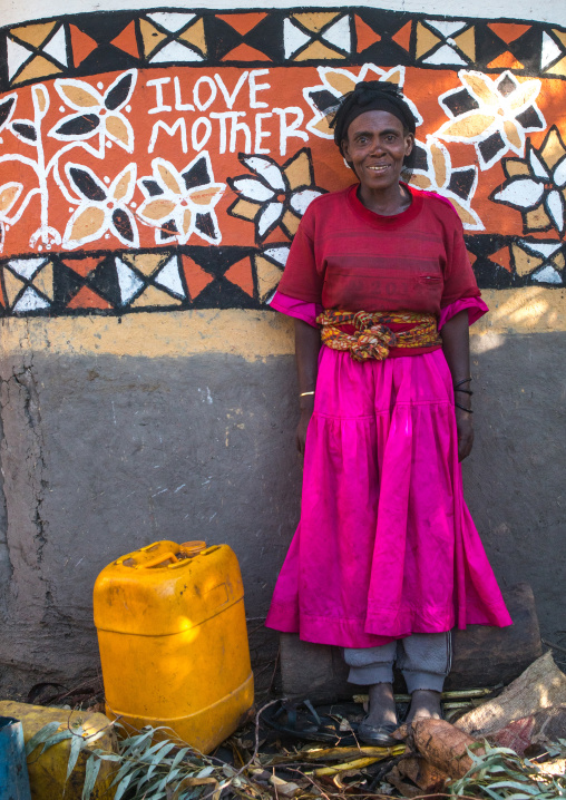 Ethiopia, Kembata, Alaba Kuito, ethiopian woman standing in front of her traditional painted house