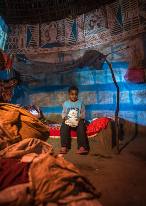 Ethiopia, Kembata, Alaba Kuito, ethiopian boy inside his traditional painted and decorated house