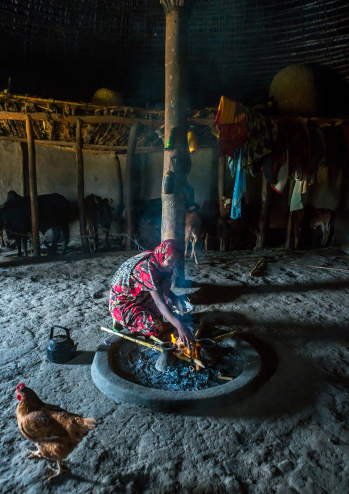 Ethiopia, Kembata, Alaba Kuito, ethiopian woman inside her traditional painted and decorated house making fire