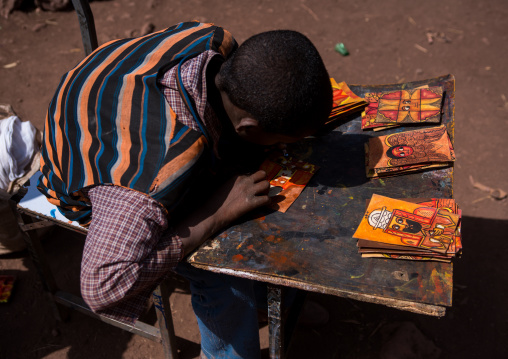 Teenage boy painting some orthodox icons, Amhara region, Lalibela, Ethiopia