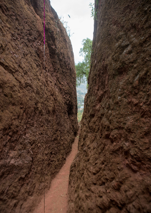 Narrow path to a monolithic rock-cut church, Amhara region, Lalibela, Ethiopia